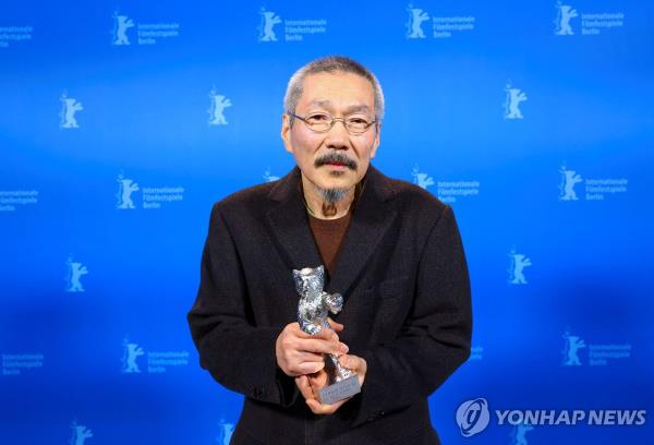 South Korean director Hong Sang-soo poses with the Silver Bear Grand Jury Prize for